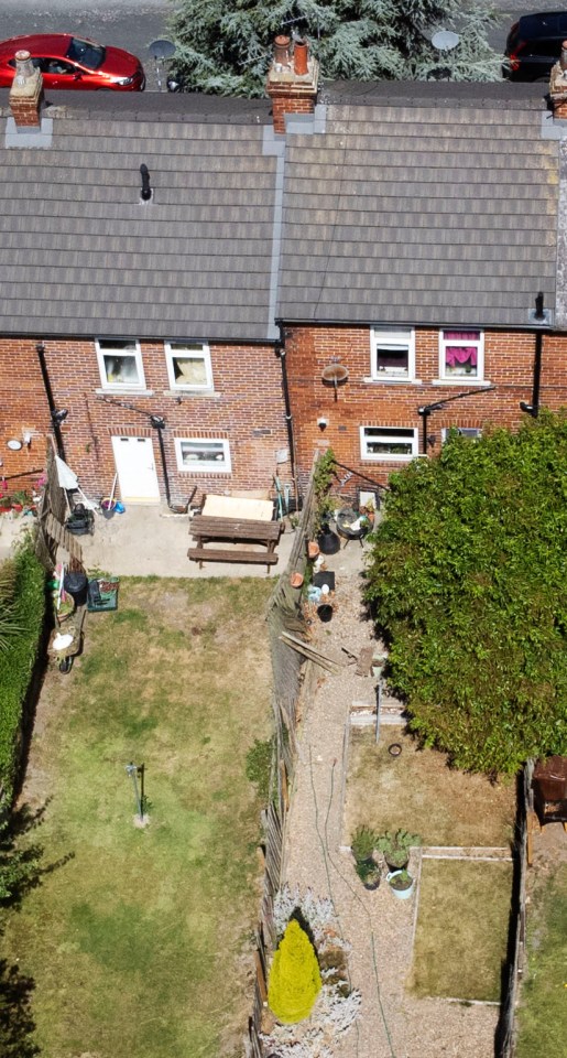 The neighbours’ homes sit side by side and are separated by the wooden fence