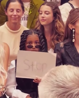 Kim Kardashian's daughter North stole the attention at Paris Fashion Week when she wrote a big sign saying 'STOP' and held it up to the paparazzi who would not stop taking pictures of her