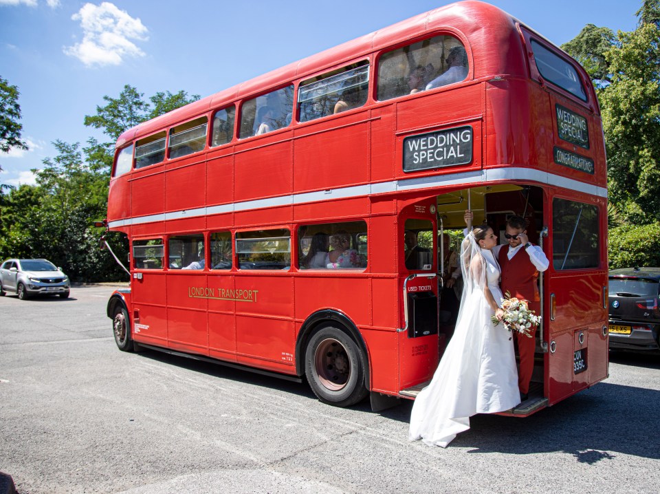 The newlyweds posed in front of their special double decker bus