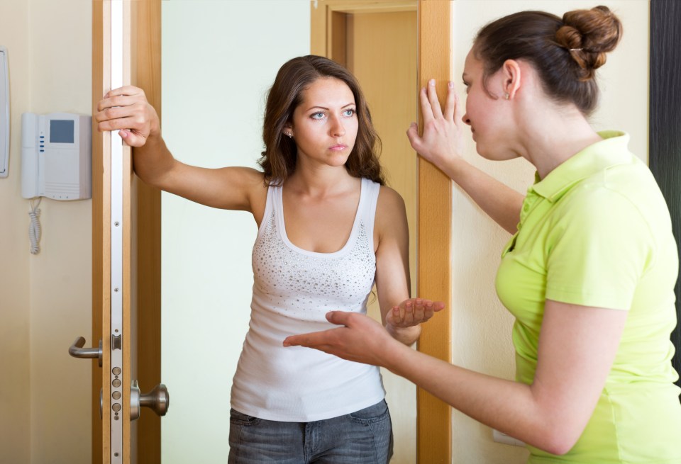 Displeased young woman visiting neighbour at the door