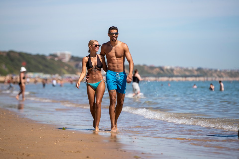 Bournemouth University students Moses Singh, 21, and Isobel Robertson, 20, are enjoying the scorching weather in Dorset