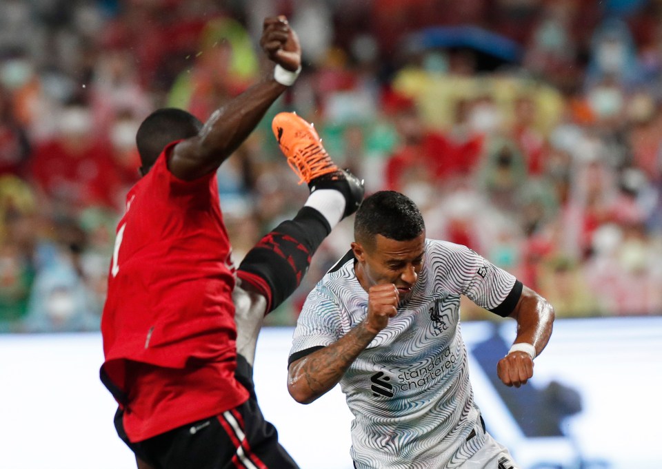 Eric Bailly, left, challenges Thiago, right, during the match between Liverpool and Man United