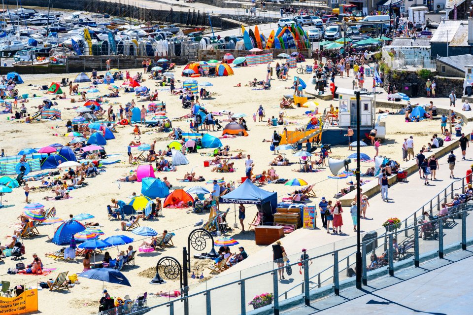 Beachgoers flocked to the seaside resort of Lyme Regis to soak up the sun