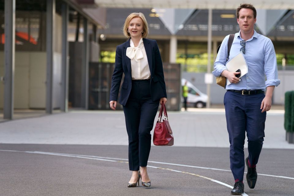 Liz Truss arrives at last night's Tory leadership debate with an aide