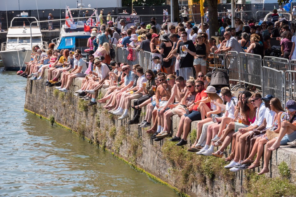 Crowds sit on the harbour wall at the Bristol Harbour Festival