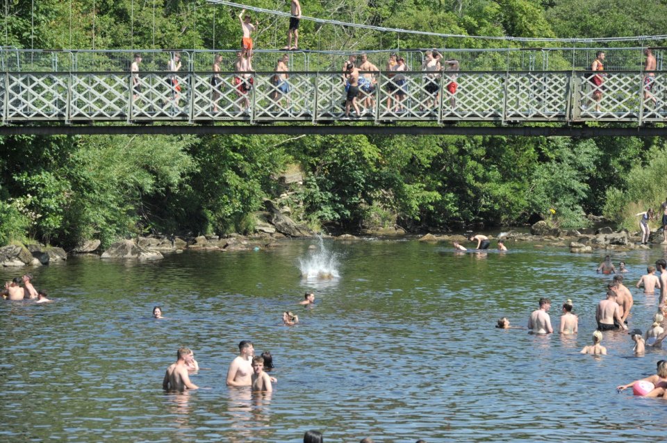 Sunseekers were seen jumping from a bridge and into the cool water below in Yorkshire