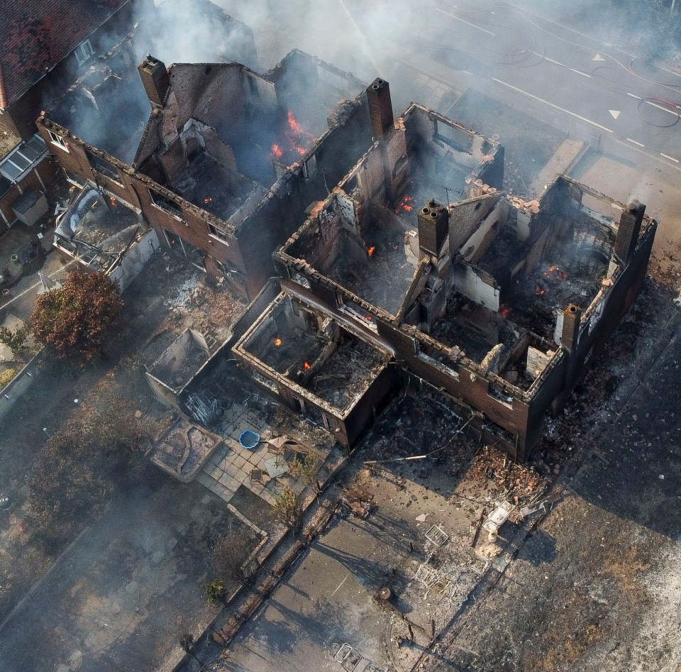 Aerial footage shows smouldering remains of row of homes