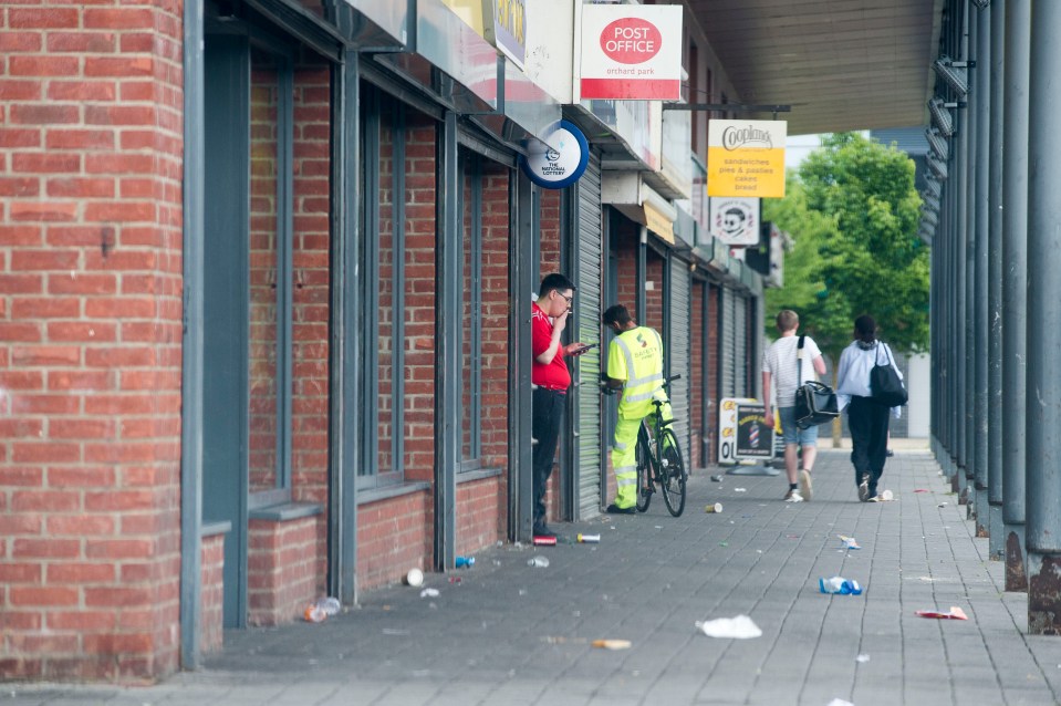 Litter lines the street of a rundown row of shops in Kingston-upon-Hull