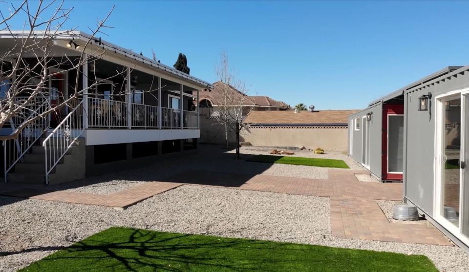 The container homes are in the back harden of the main house