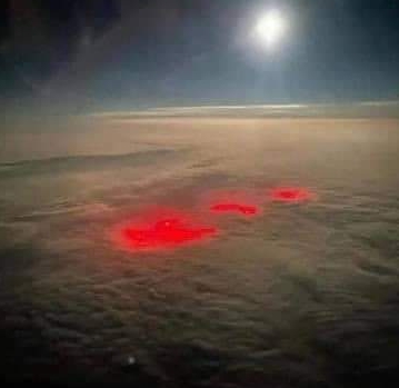 The mysterious red glow was captured by a pilot flying over the Atlantic Ocean