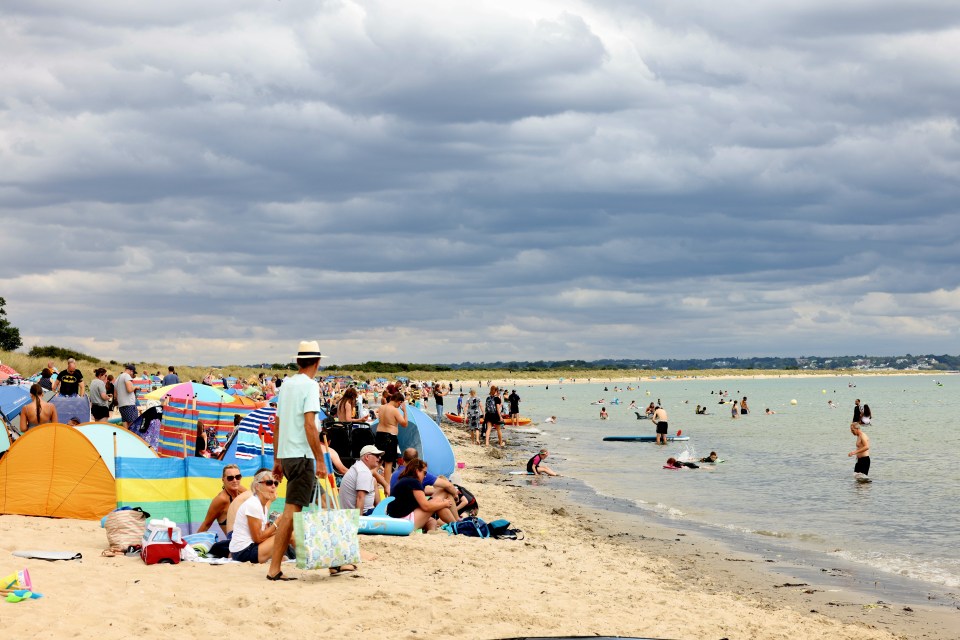 Dark clouds fill the sky over Knoll Beach near Studland, Dorset