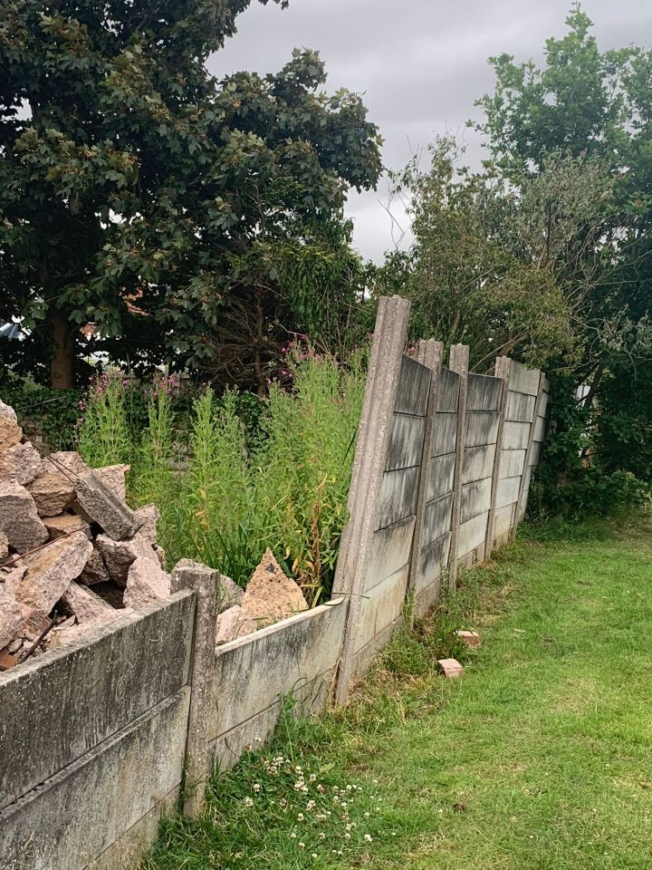 Landscapers knocked down the couple's garage and the adjoining brick wall to make room for the work