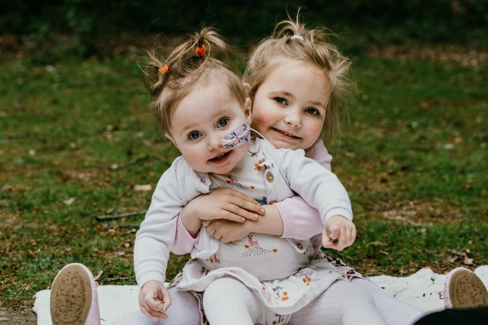 Liver transplant tot Lola Rose Clyde, 2,  — who had only two weeks to live before surgery — is hugged by sister Paisley Mae