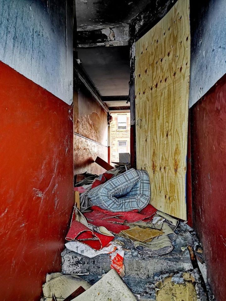 Discarded junk and old mattresses litter the hallways