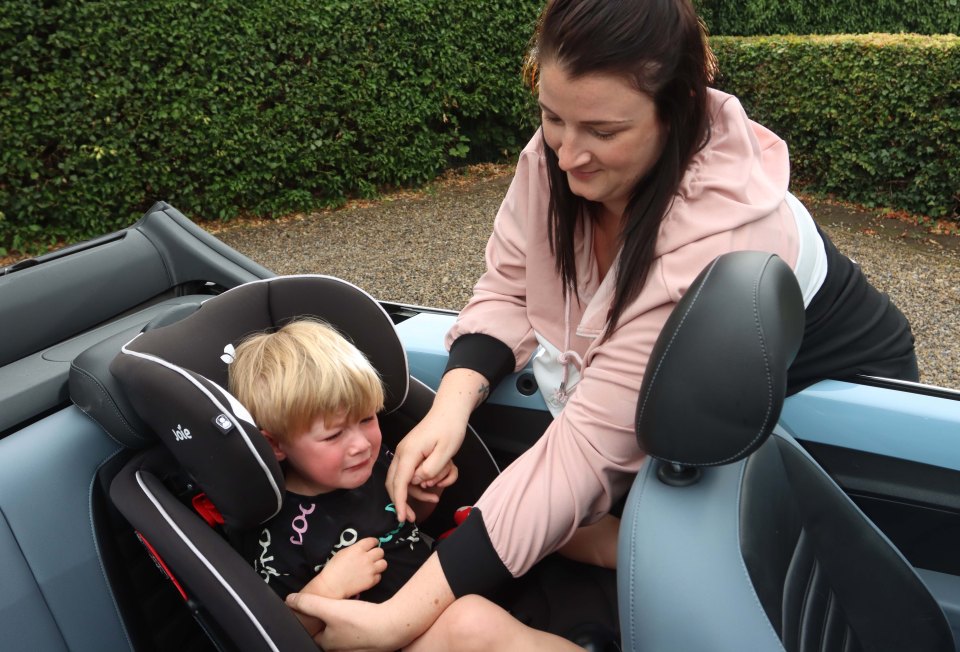 Little Alfie, two, had to be strapped back into his car seat