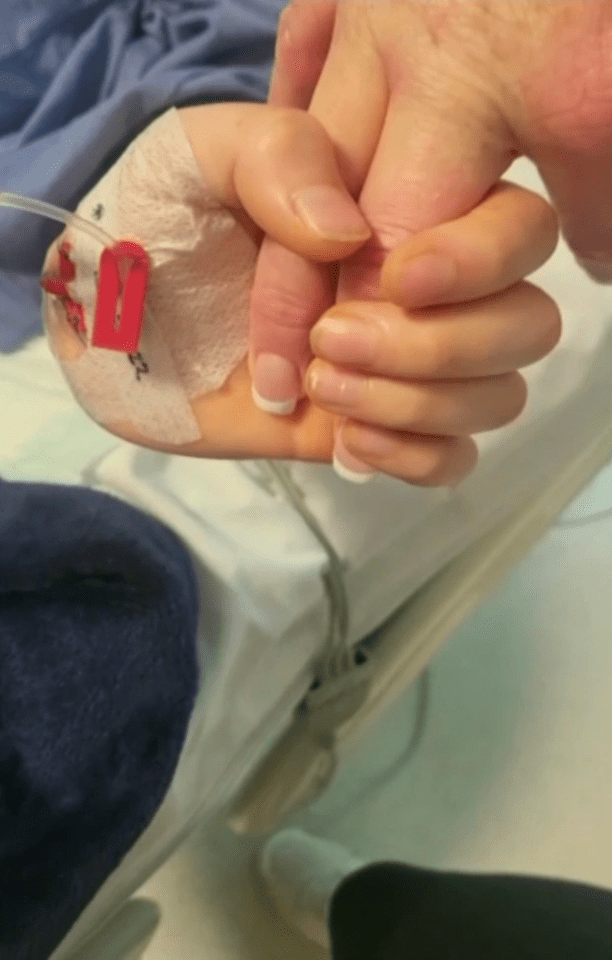 Archie, pictured with his hand around his mum’s finger, has been in a coma since April 7