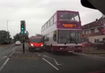 The van driver mounts the traffic island and keeps going