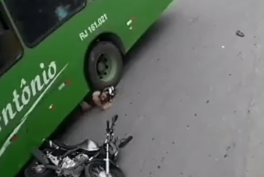 He is then pushed back along the road, but his helmet saves his life