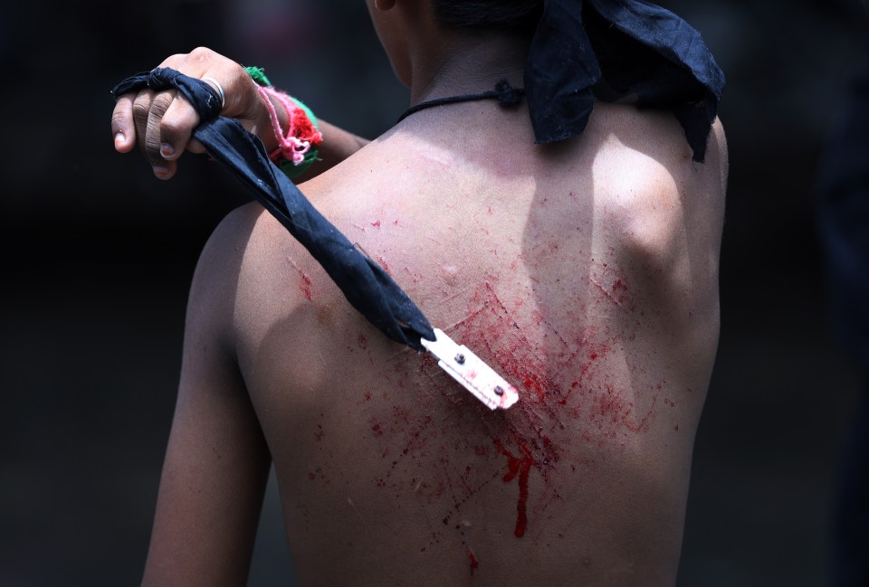 A man beats himself during a procession in Chennai, Tamil Nadu, India