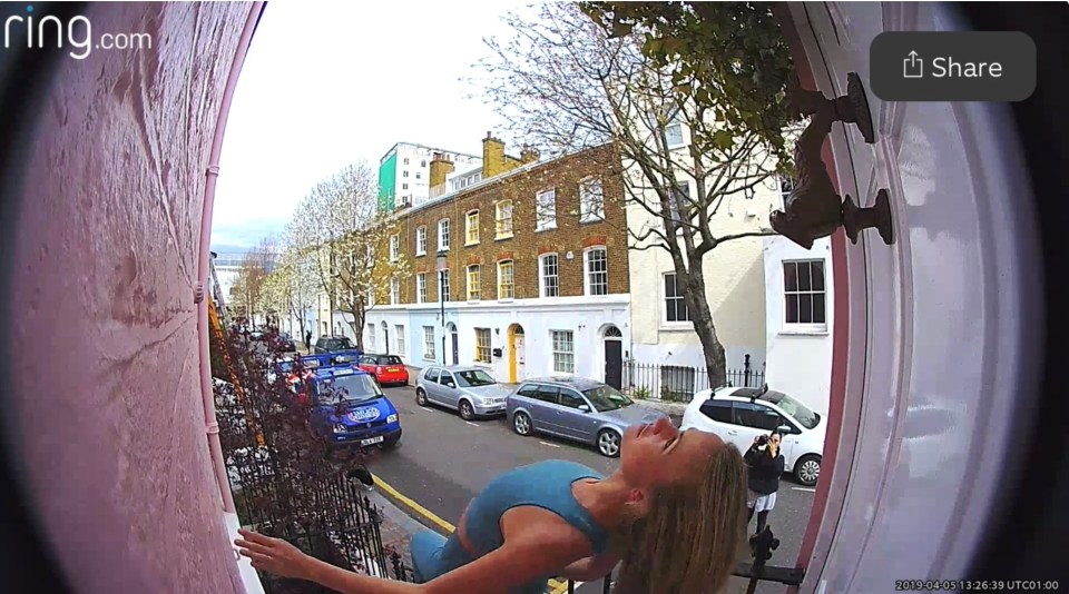 A woman is seen posing on Peter Lee's bright pink property