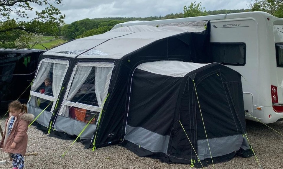 The parents attach an awning onto the side for some kids to sleep in