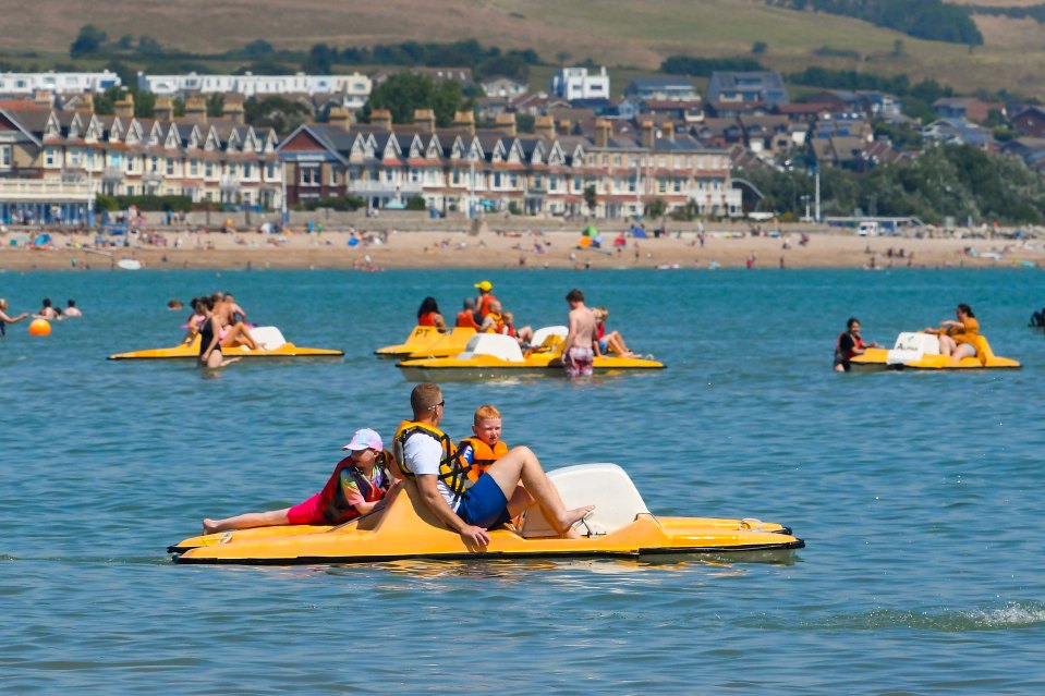 Families were seen having fun on the calm sea in Weymouth in Dorset