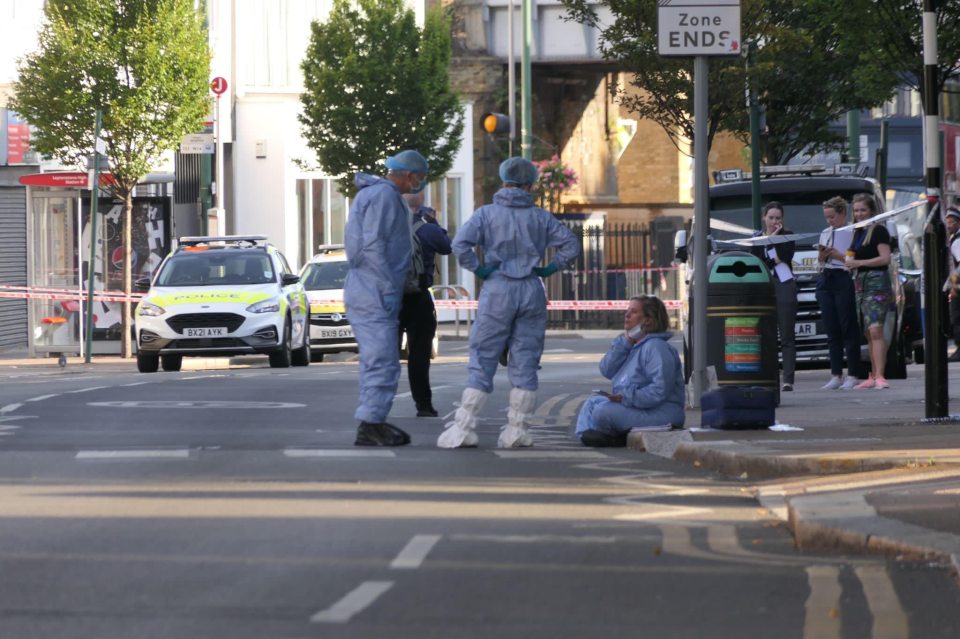 Forensic officers pictured at the scene this afternoon