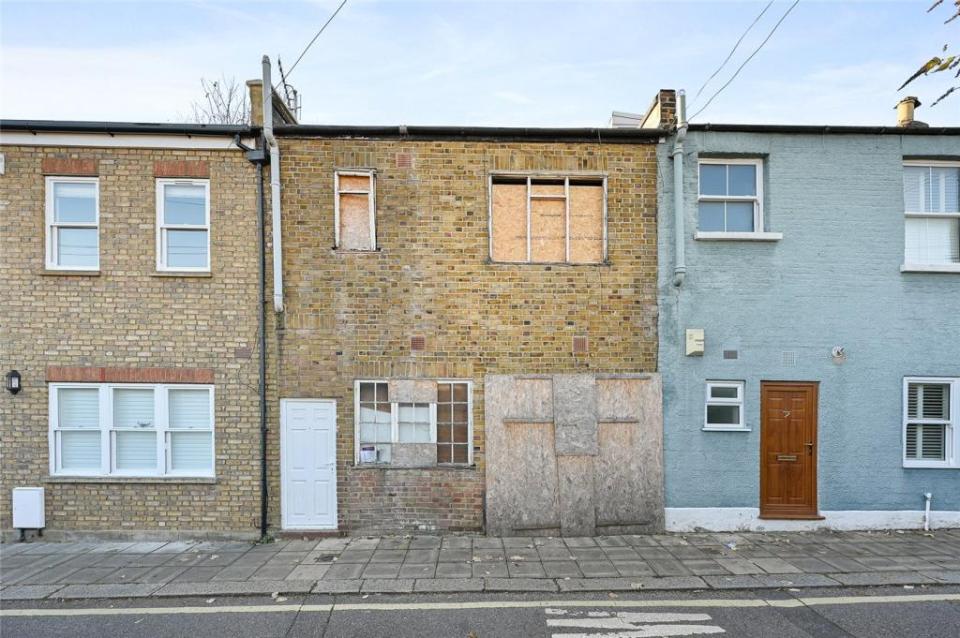 The pad sticks out in the neighbourhood with its broken windows and boarded up garage door