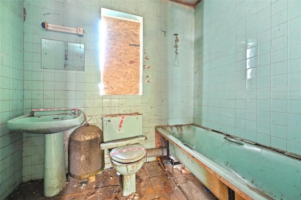 The Hammersmith home's toilet and sink both have tape across them that states "do not use"