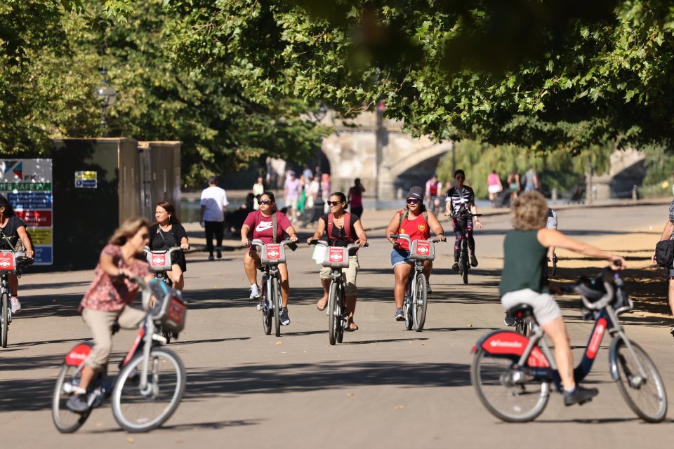 Members of the public hop on bikes in the morning heat at Hyde Park, central London