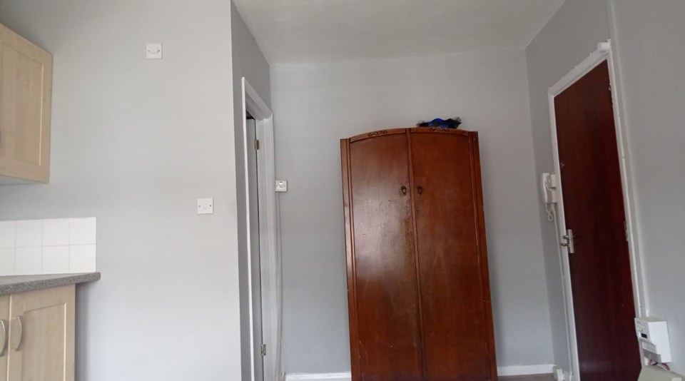 A cupboard is oddly situated next to the flat's front door