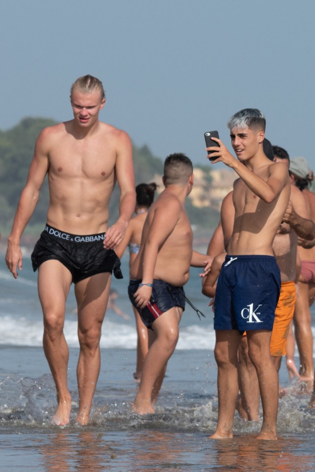 Stunned fans took pictures of the Man City ace as he walked along the beach