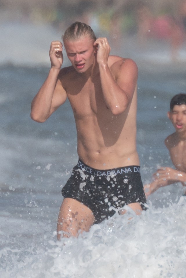 Haaland brushed back his hair as he stepped out of the waves