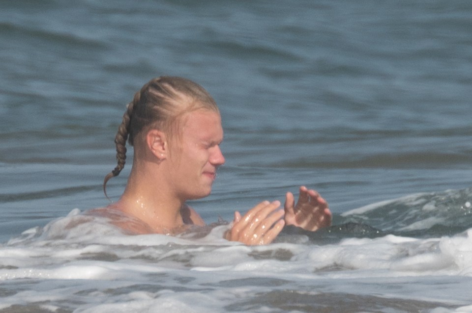 Haaland tied his long hair back for his dip in the sea