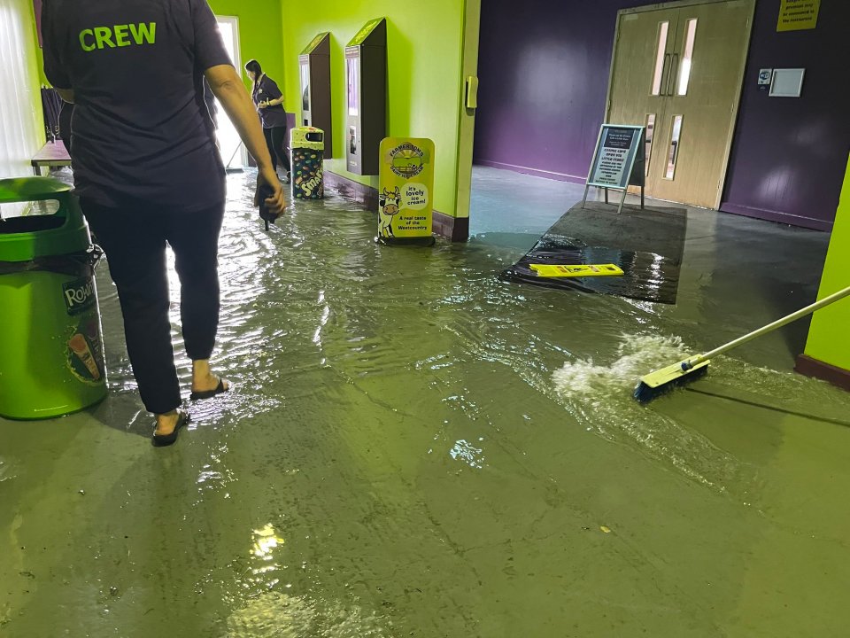 Staff at The Milky Way in Devon clearing out flood water