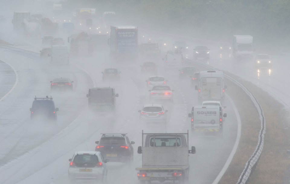 Cars battled through the rain on the M25 near Swanley, Kent