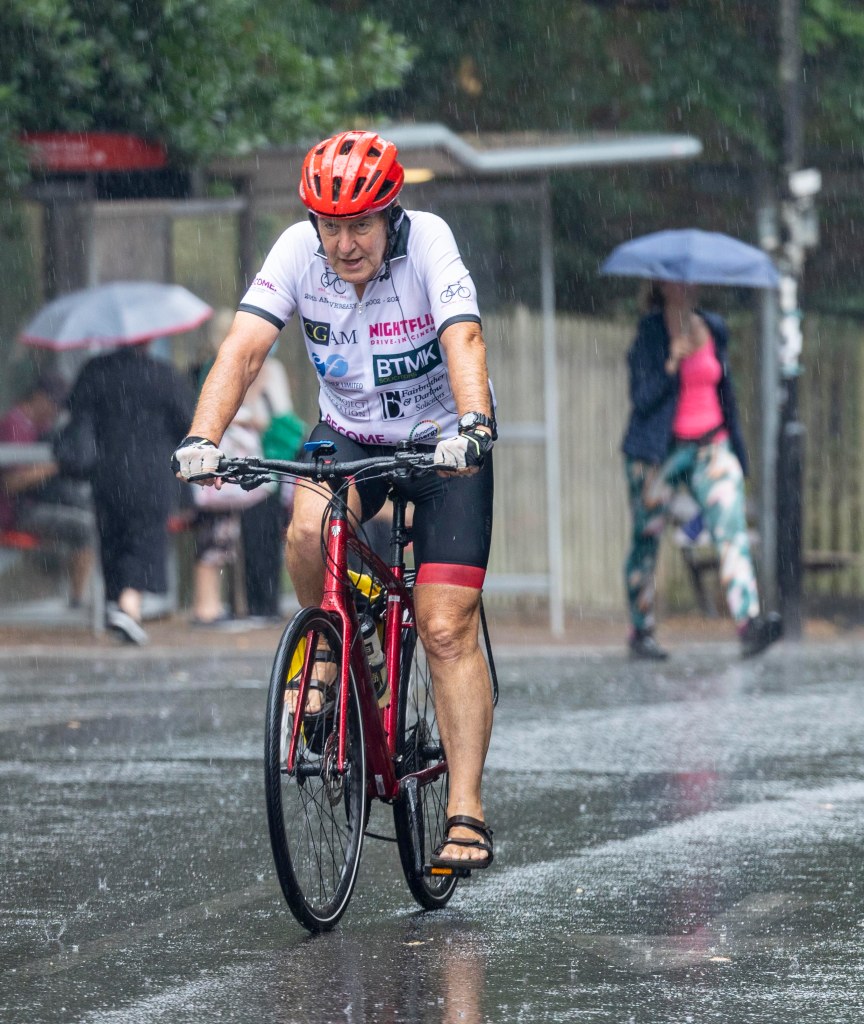 A cyclist was caught in the deluge yesterday afternoon in London