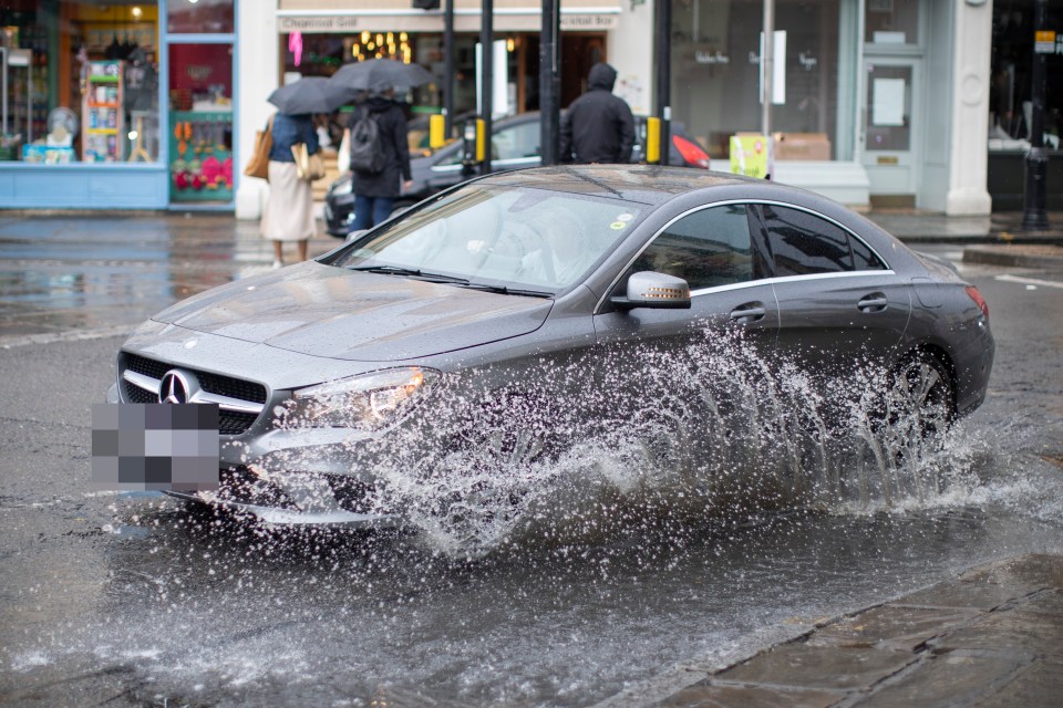 Cars battled through puddles in London