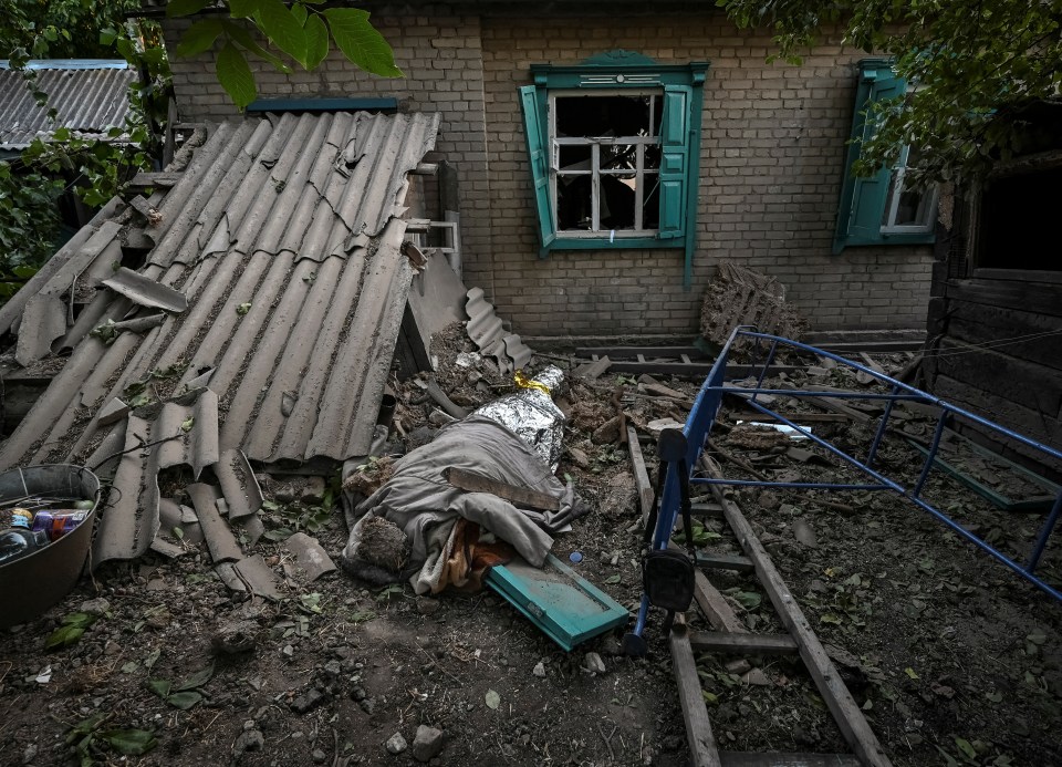 The covered body of an 11-year-old boy who was killed by a Russian military strike in Chaplyne