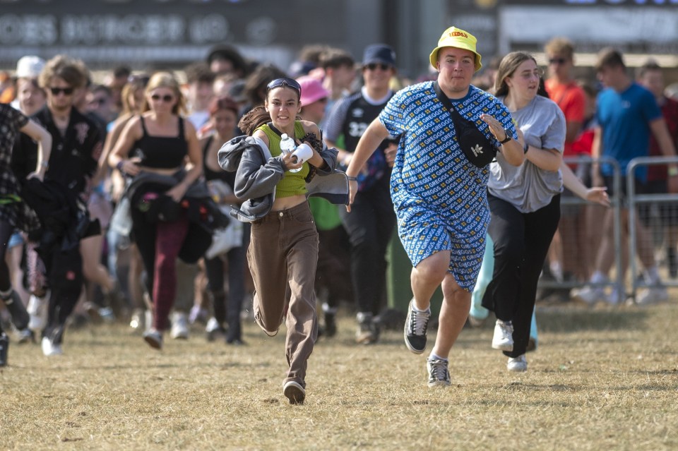 People race through the barriers to the main arena at the Leeds site