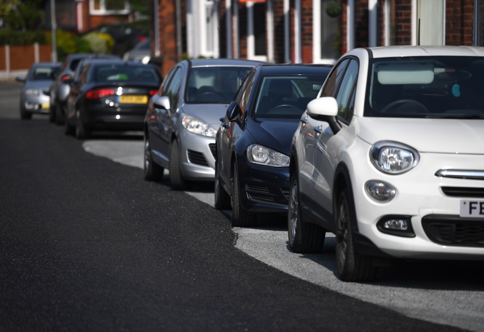 Bungling council workers have resurfaced the road around the parked cars of local motorists