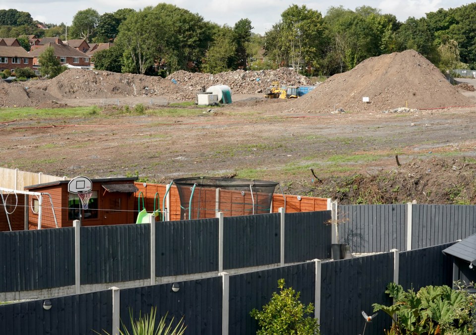 Residents say huge mounds of dirt sit behind their homes, filling their gardens with dust