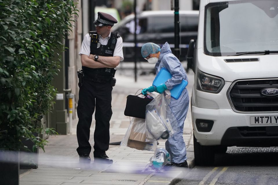 Forensic officers gathered bags of evidence after the stabbing