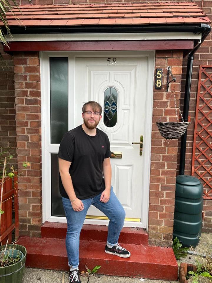 Dylan Heath outside his house in Oldham