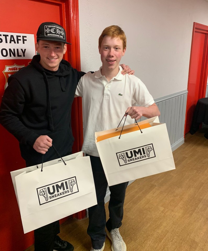 15-year-old Henry Moffat, who owns Umi Sneakers, poses with client Louie Barry of Aston Villa