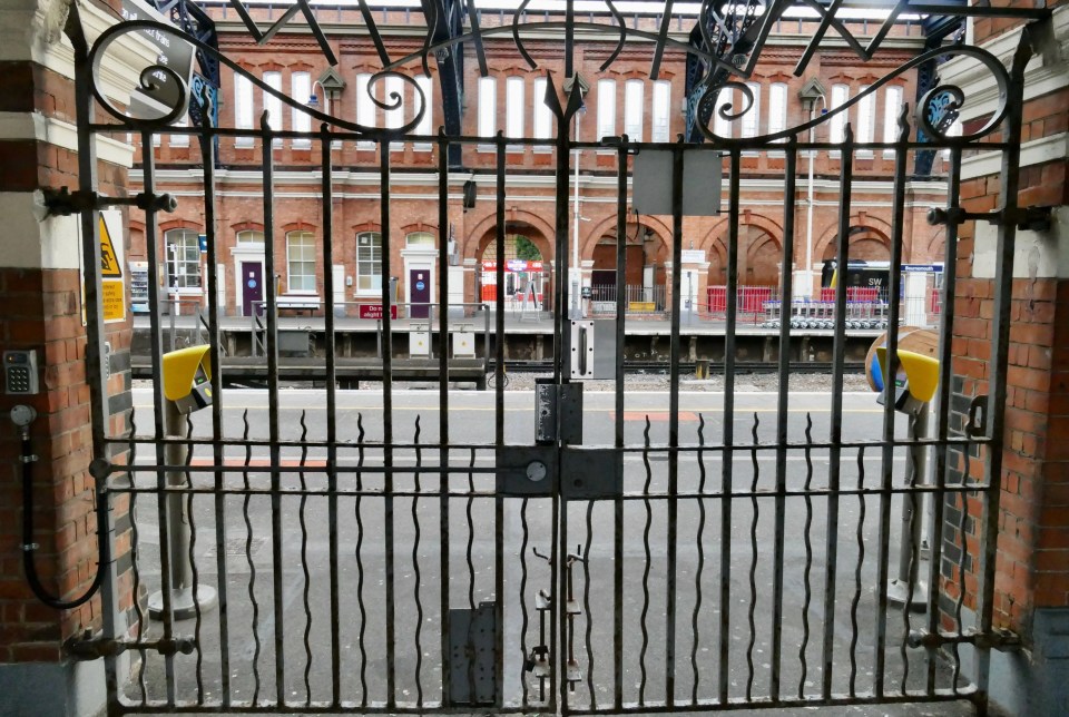 The gates at Bournemouth train station are locked today - as holiday-makers attempt to reach the resort in 25C sunshine