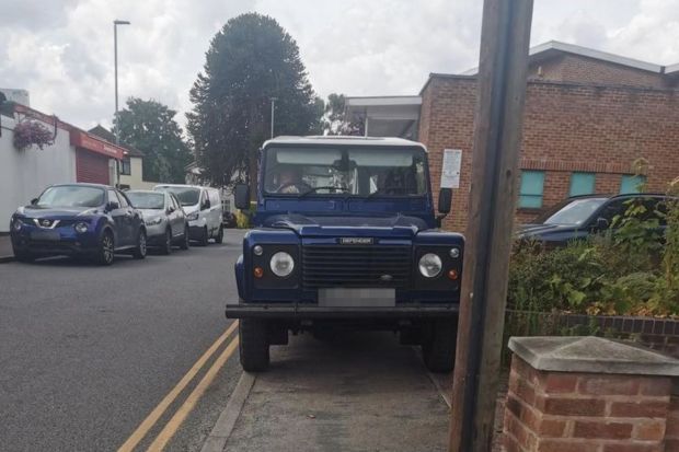 Land Rover Defender driver parked on pavement in Leicestershire town