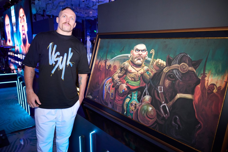 Ukrainian Usyk alongside a painting of himself