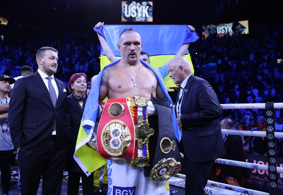 Usyk celebrates with his collection of belts