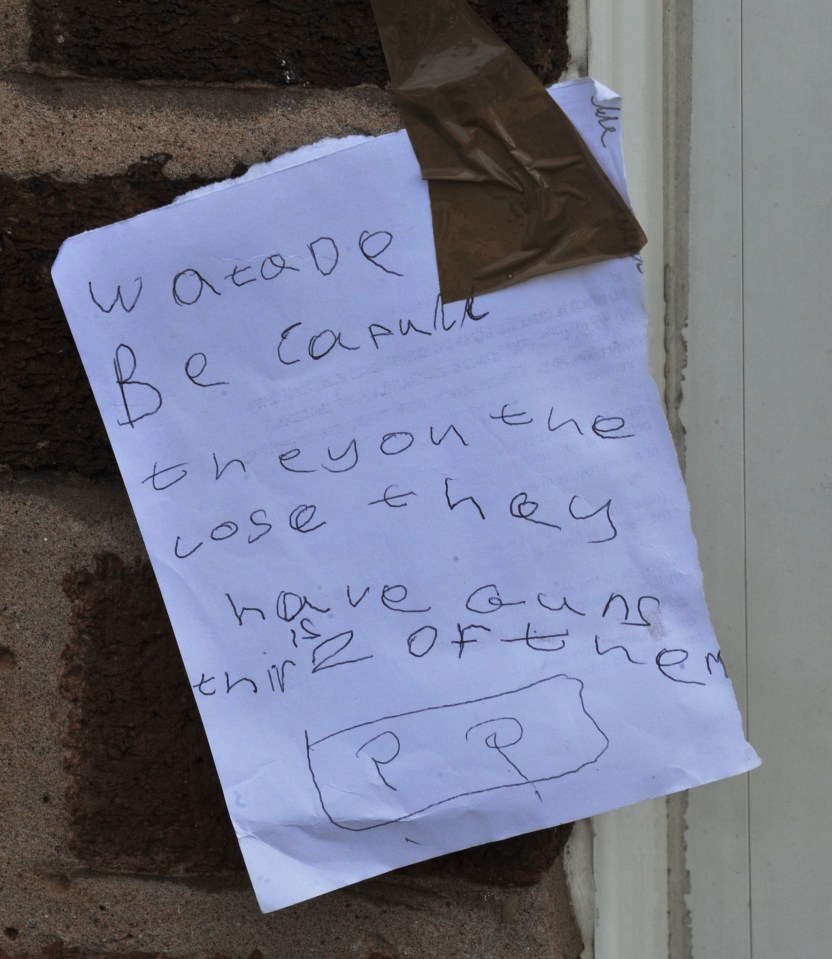 A note on the door of the house where a nine-year-old girl was shot dead